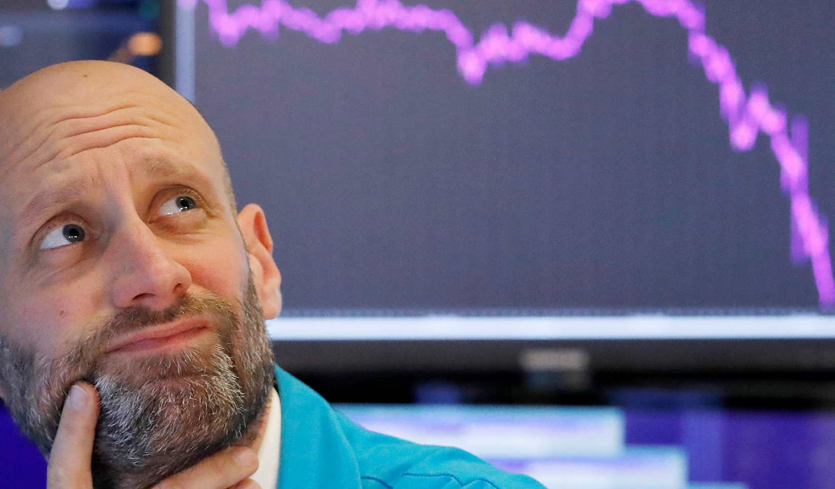 A trader reacts as he works on the floor of the New York Stock Exchange in New York City. Photo by: Reuters/Andrew Kelly