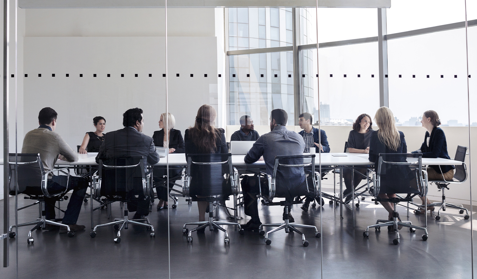 Colleagues gathered for a board meeting. Credit: iStock/FangXiaNuo