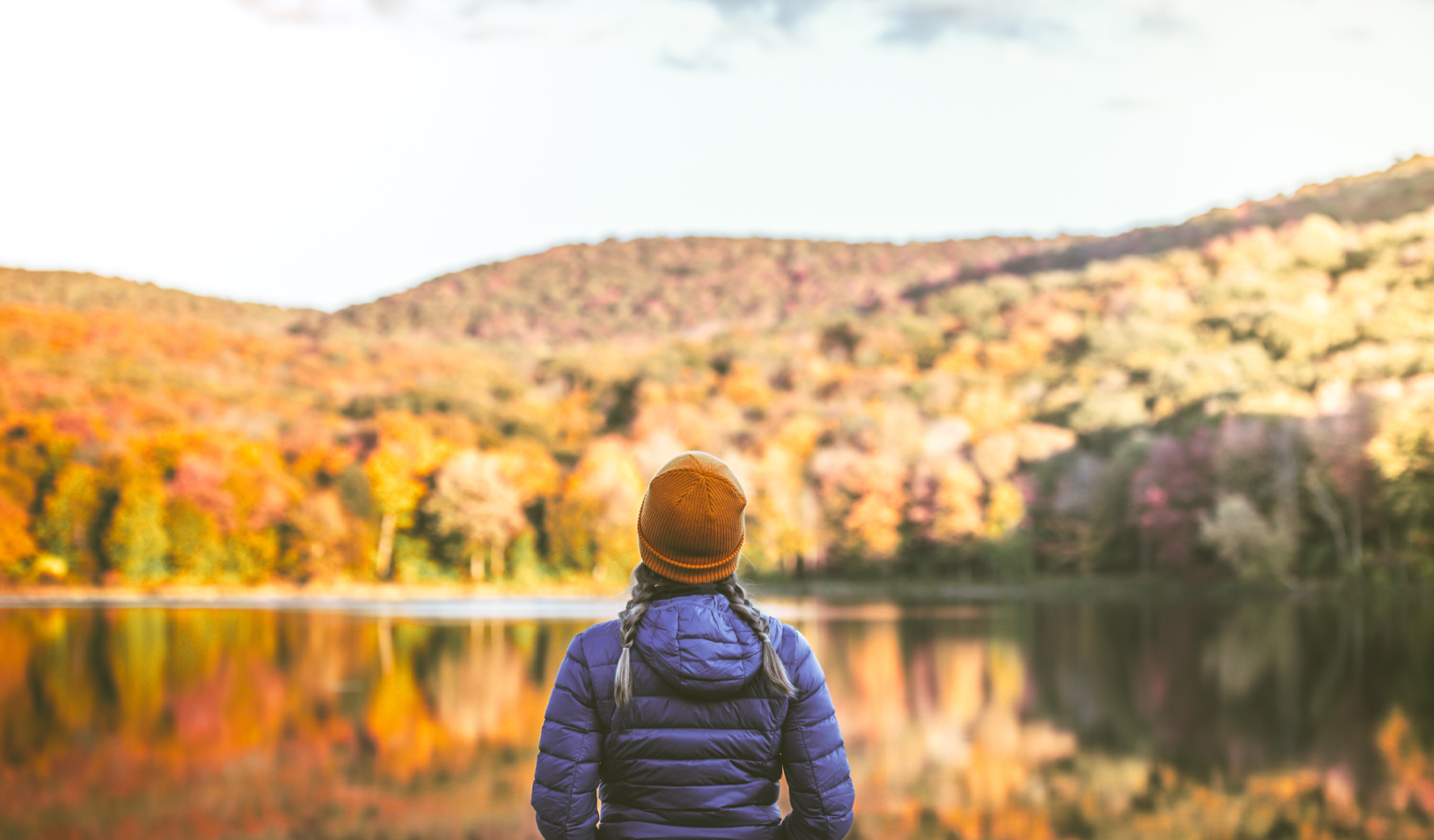 Young woman alone in nature surrounded by beautiful autumn colors. | Credit: iStock/MundusImages.