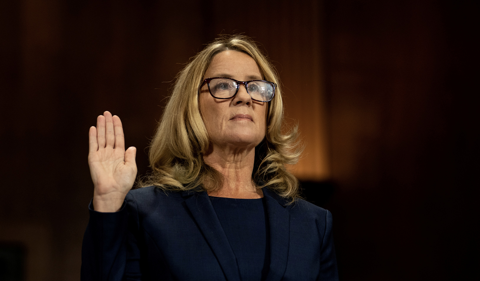 Christine Blasey Ford swears in at a Senate Judiciary Committee hearing for her to testify about sexual assault allegations against Supreme Court nominee Judge Brett M. Kavanaugh. | Credit: REUTERS/Erin Schaff.