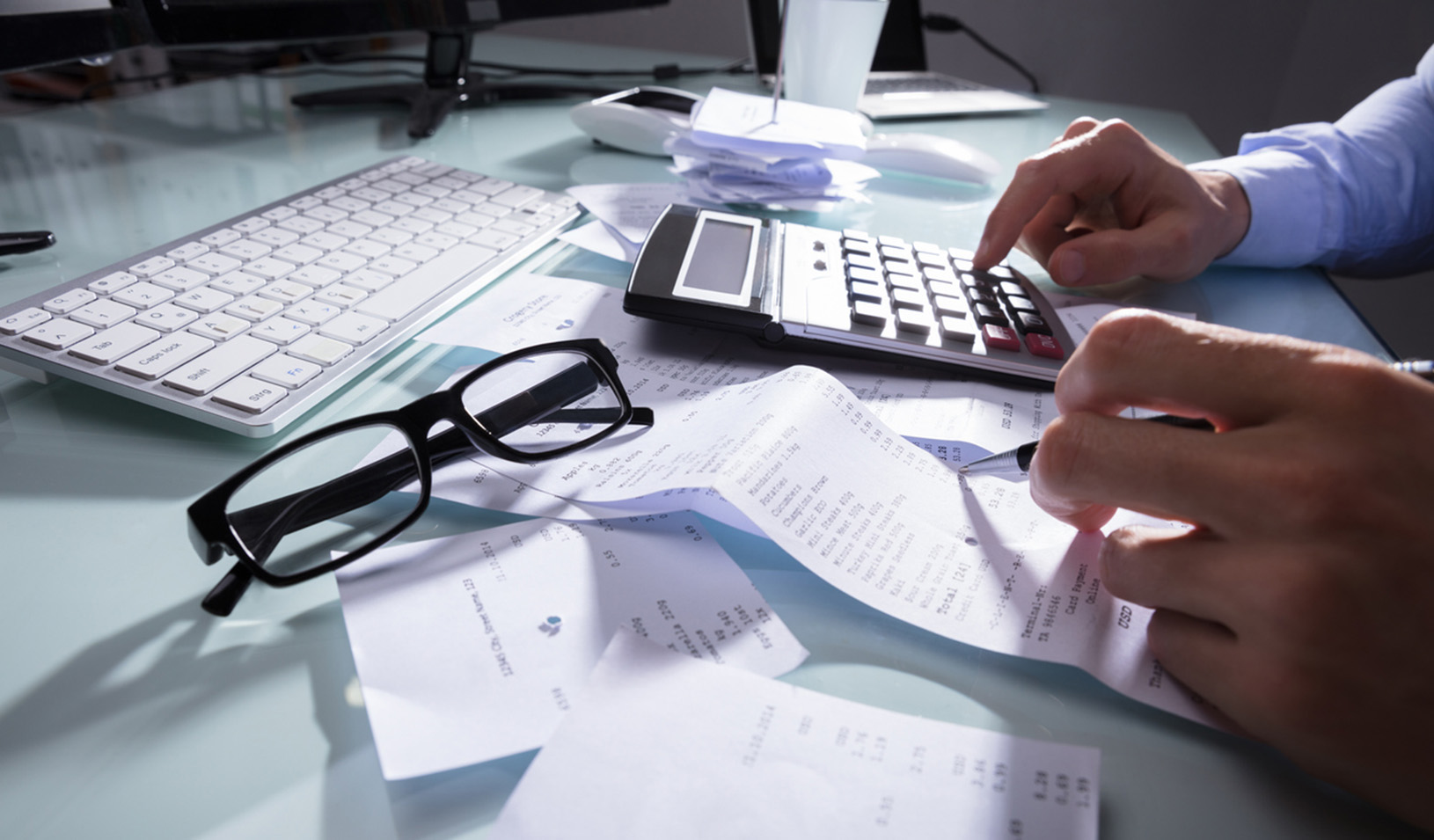 Close up of someone's desk as they are doing bills/accounting. iStock/AndreyPopov