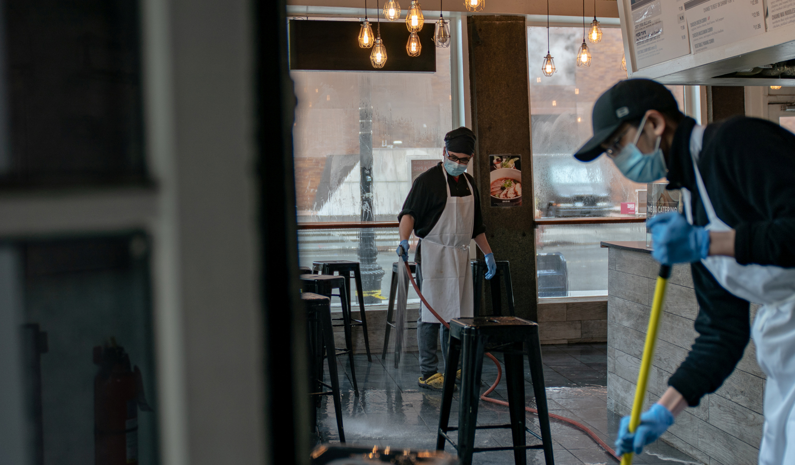 Restaurant staff clean the floor after closing early afternoon following the outbreak of coronavirus disease (COVID-19), in New York City, U.S., March 16, 2020. Credit: Reuters/Jeenah Moon