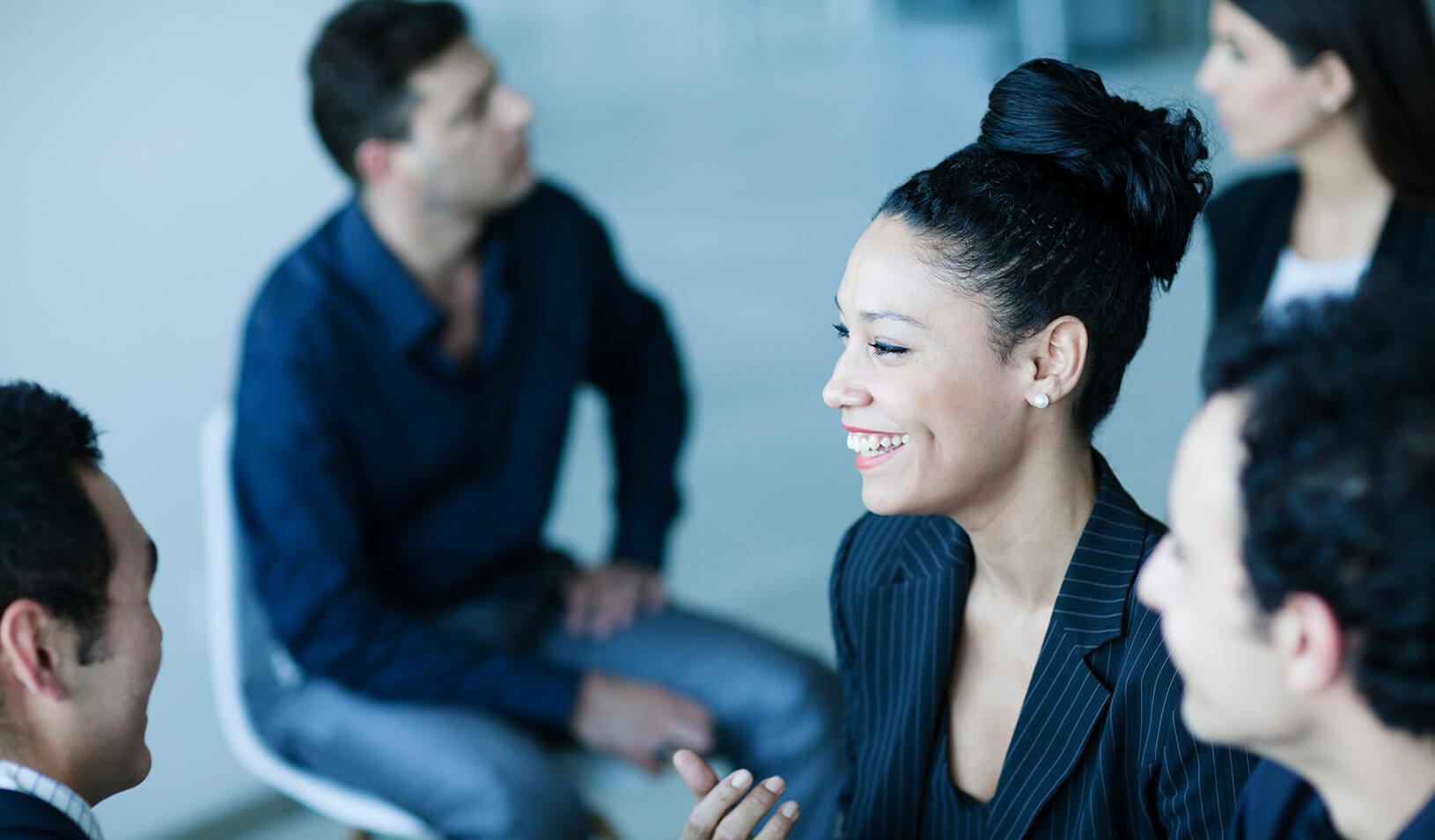 A group of people talking | iStock/XiXinXing 