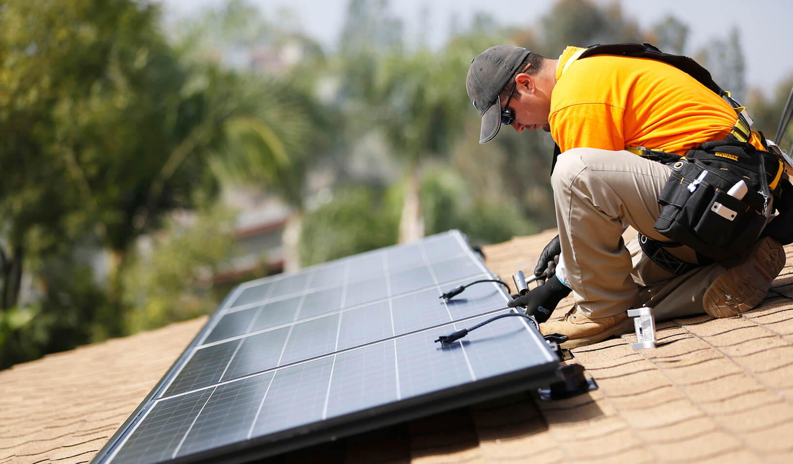 A solar technician installs panels on the roof of a house | Reuters/Mario Anzuoni