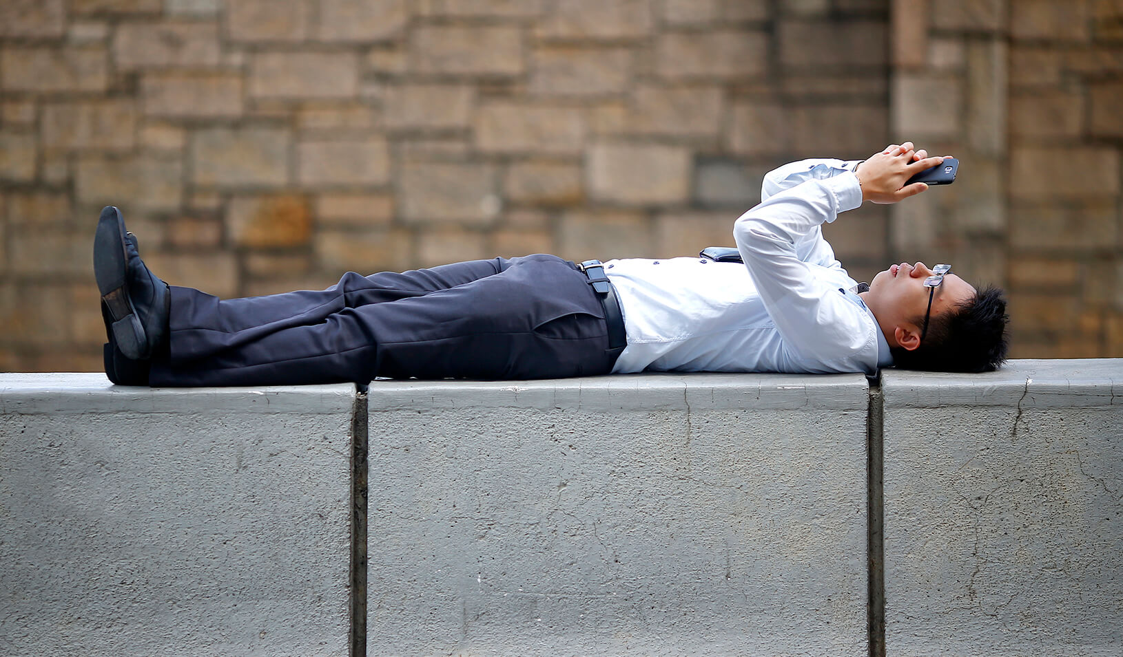 A man watches videos on his phone | Reuters/Damir Sagolj