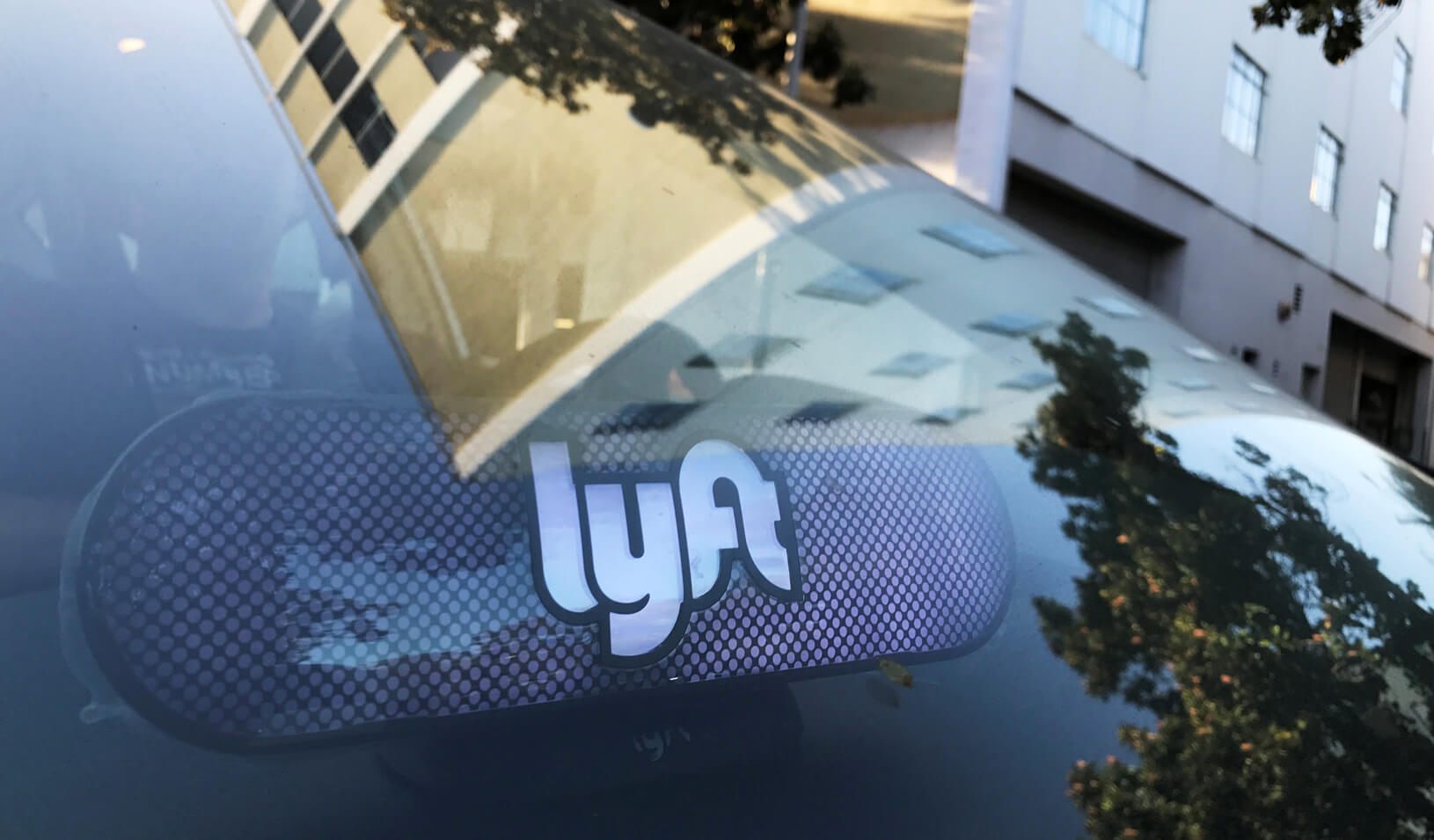 An illuminated sign appears in a Lyft ride-hailing car. Credit: Reuters/Chris Helgren