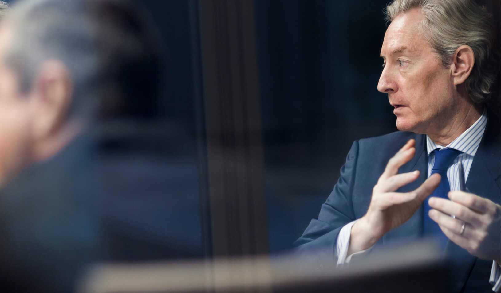 A senior businessman at a meeting. Credit: iStock/FangXiaNua