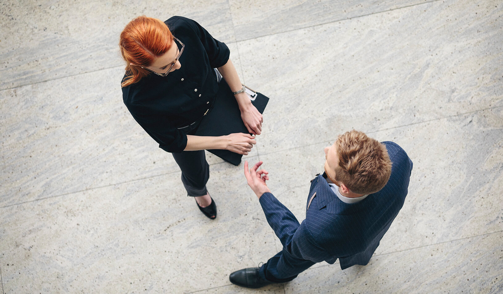 Two people talking | iStock/danchooalex