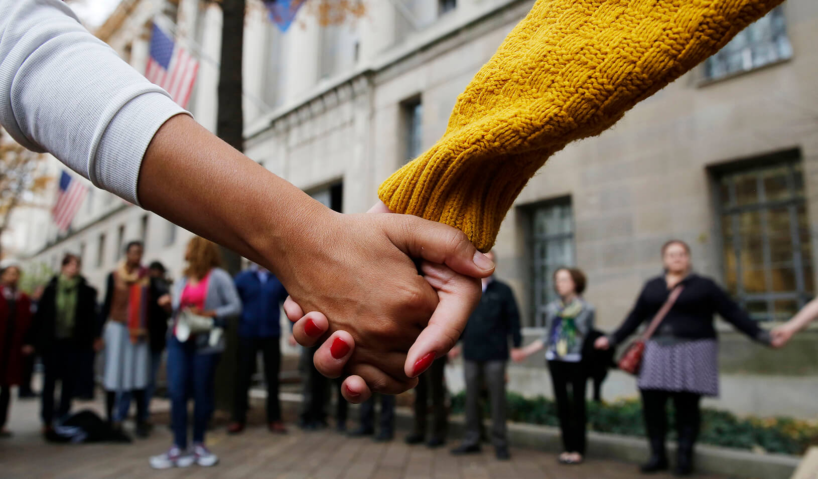 A circle of protestors holding hands