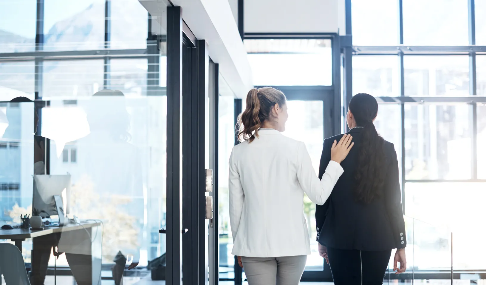 A woman puts her hand on a colleague’s shoulder. Credit: iStock/shapecharge