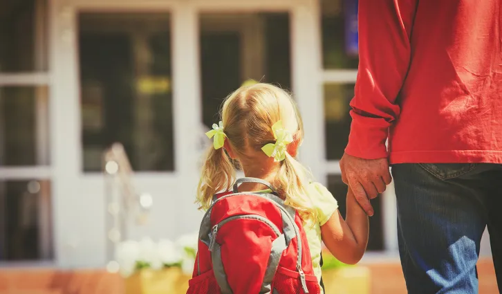 A father walking his young daughter to daycare. | Credit: iStock/Nadezhda1906.