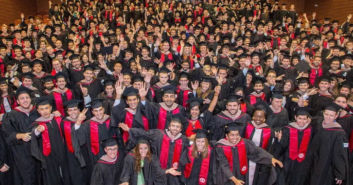 The Stanford MBA Class of 2017 gathers in CEMEX Auditorium before the commencement processional. | Saul Bromberger