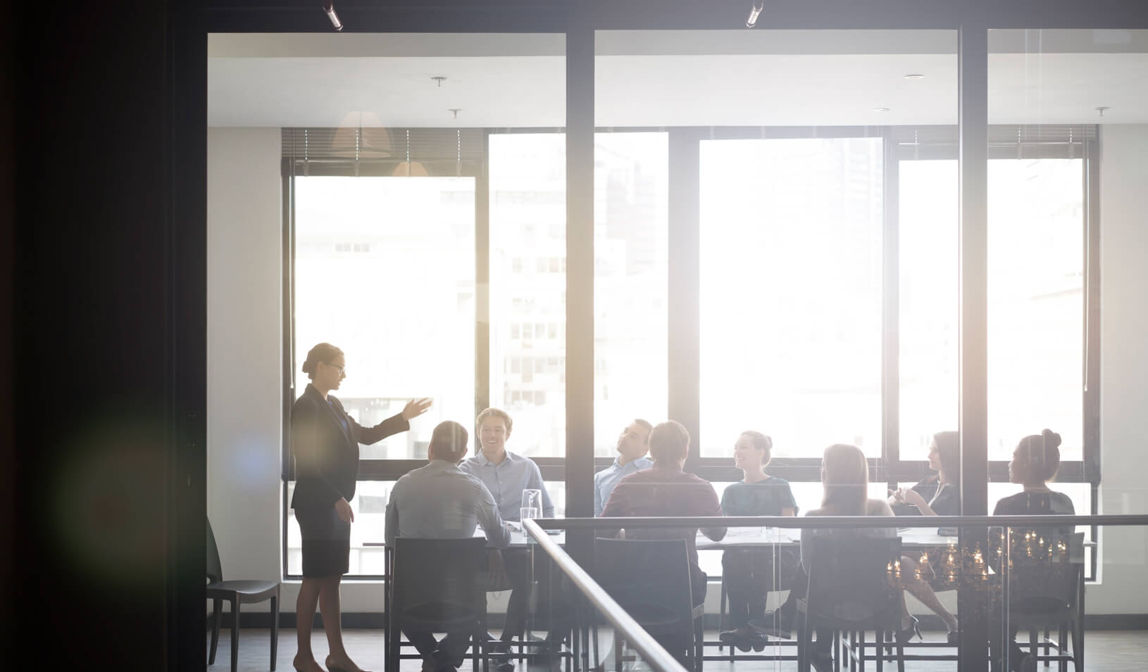 A woman presenting to colleagues. Credit: iStock/Portra